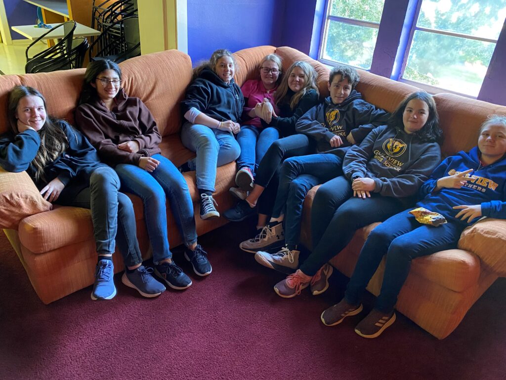 A youth church group hanging out on a couch