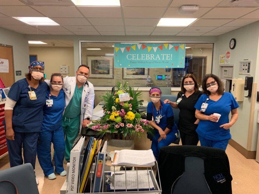 Nurses and doctors pose with our gift of flowers