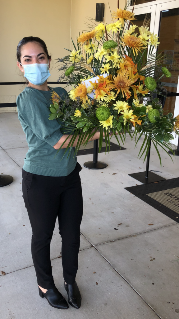 A woman poses with a bouquet of flowers from First UMC