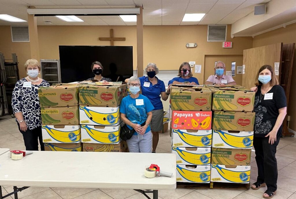 The First UMC crew posing with pallets of food to send out